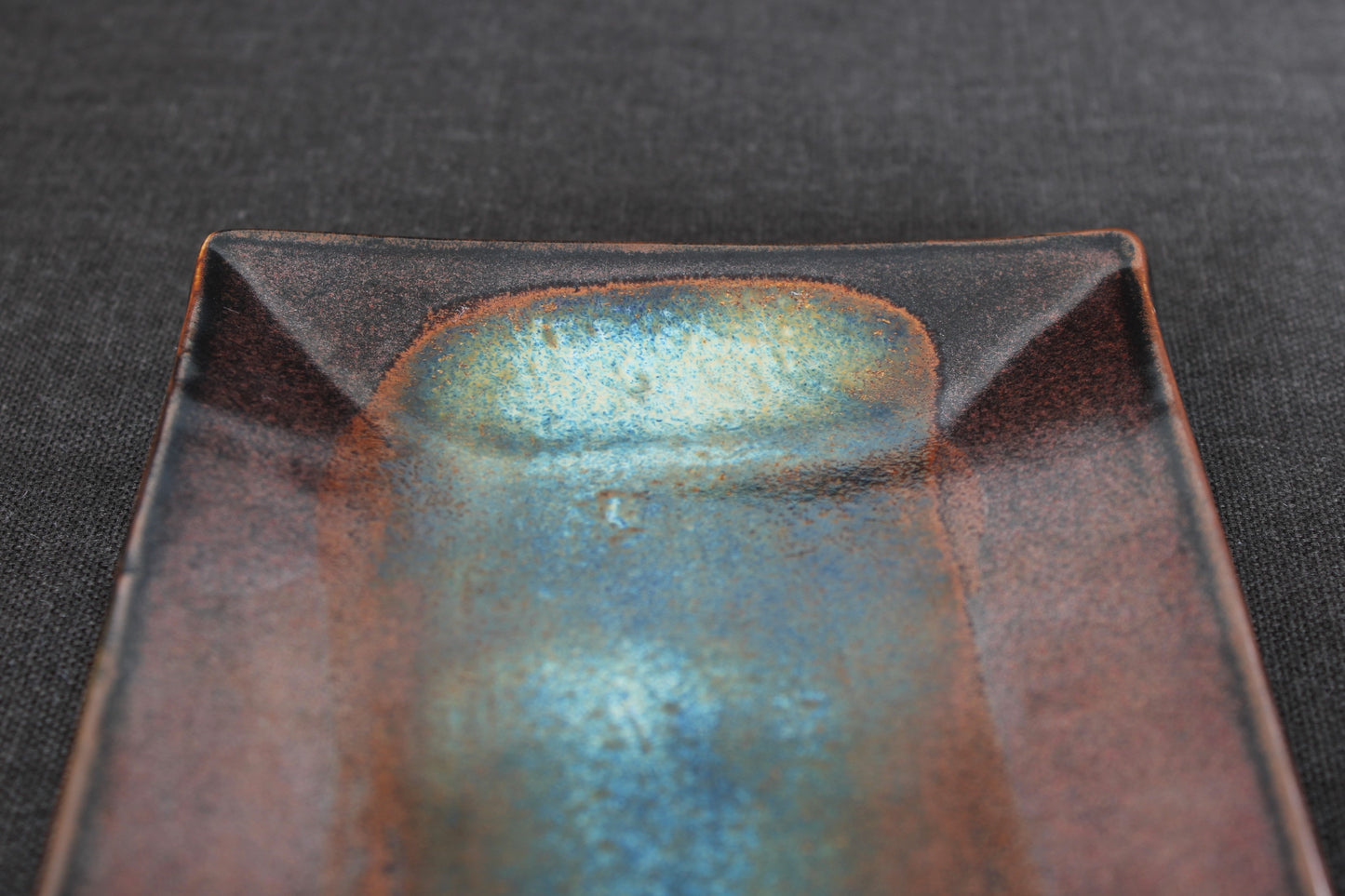 handmade japanese sushi plate with tenmoku glaze top view