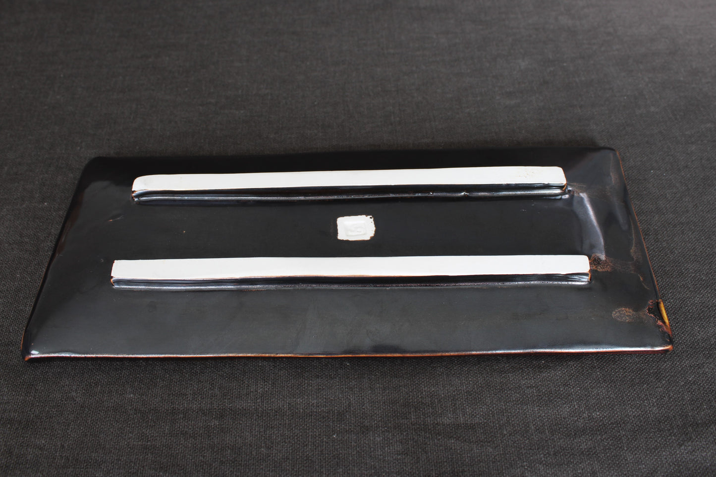 sushi plate with tenmoku glaze bottom view