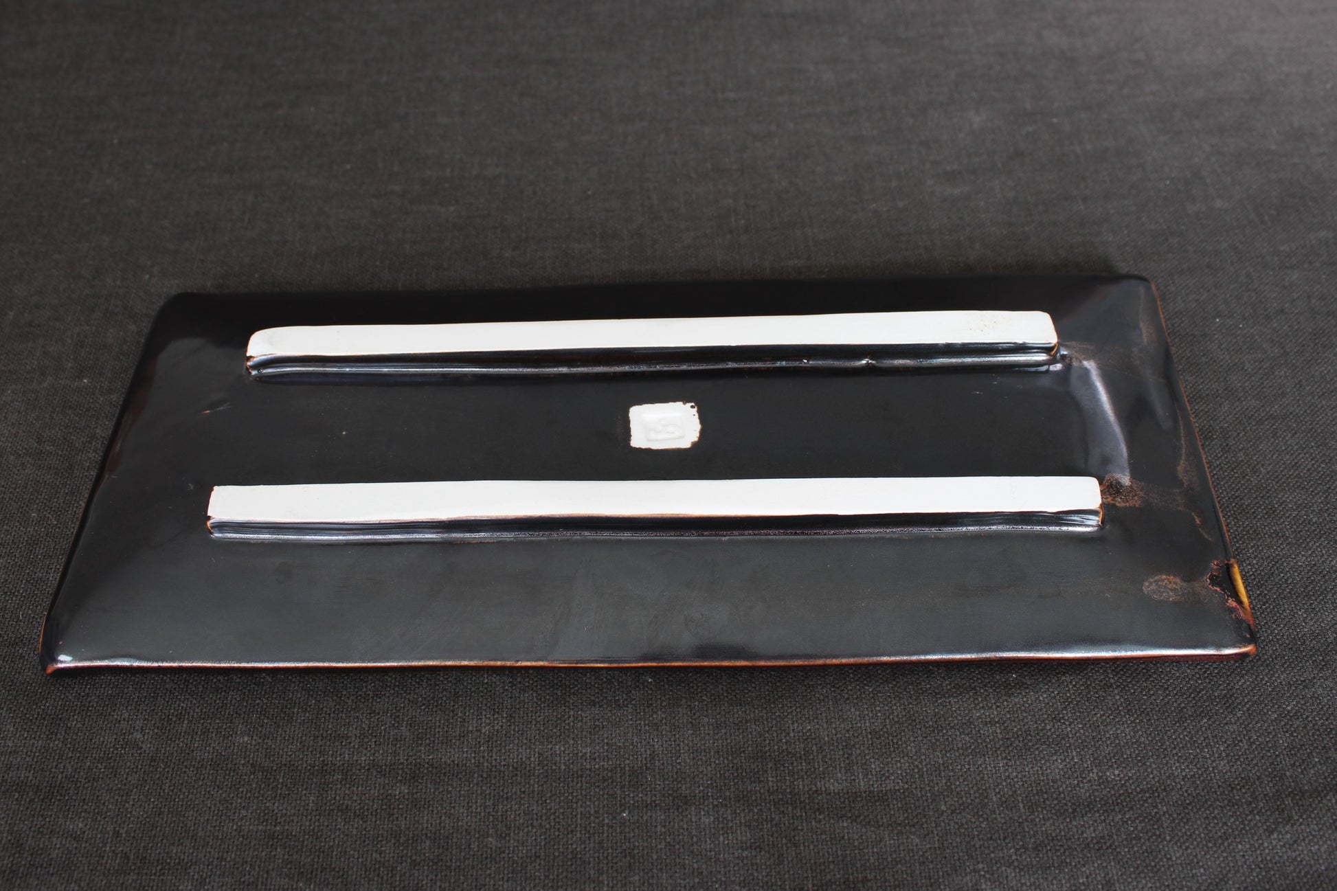 sushi plate with tenmoku glaze bottom view