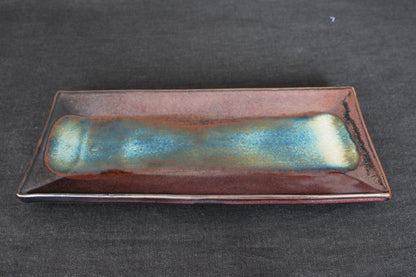 sushi plate with tenmoku glaze top view