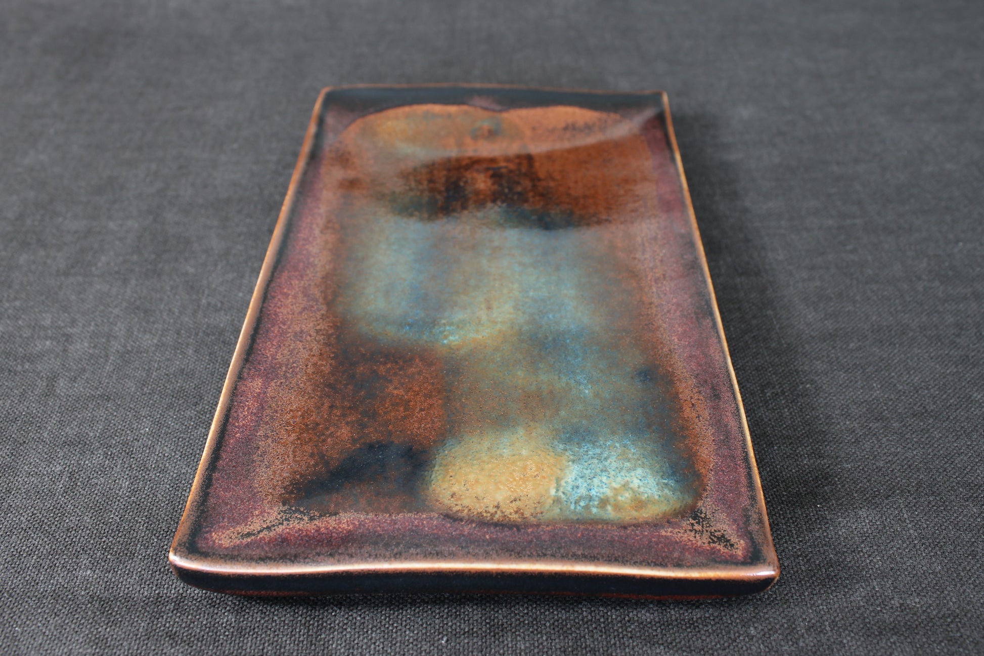 sushi plate with tenmoku glaze top view