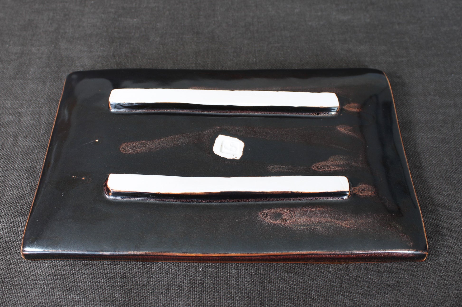 sushi plate with tenmoku glaze bottom view