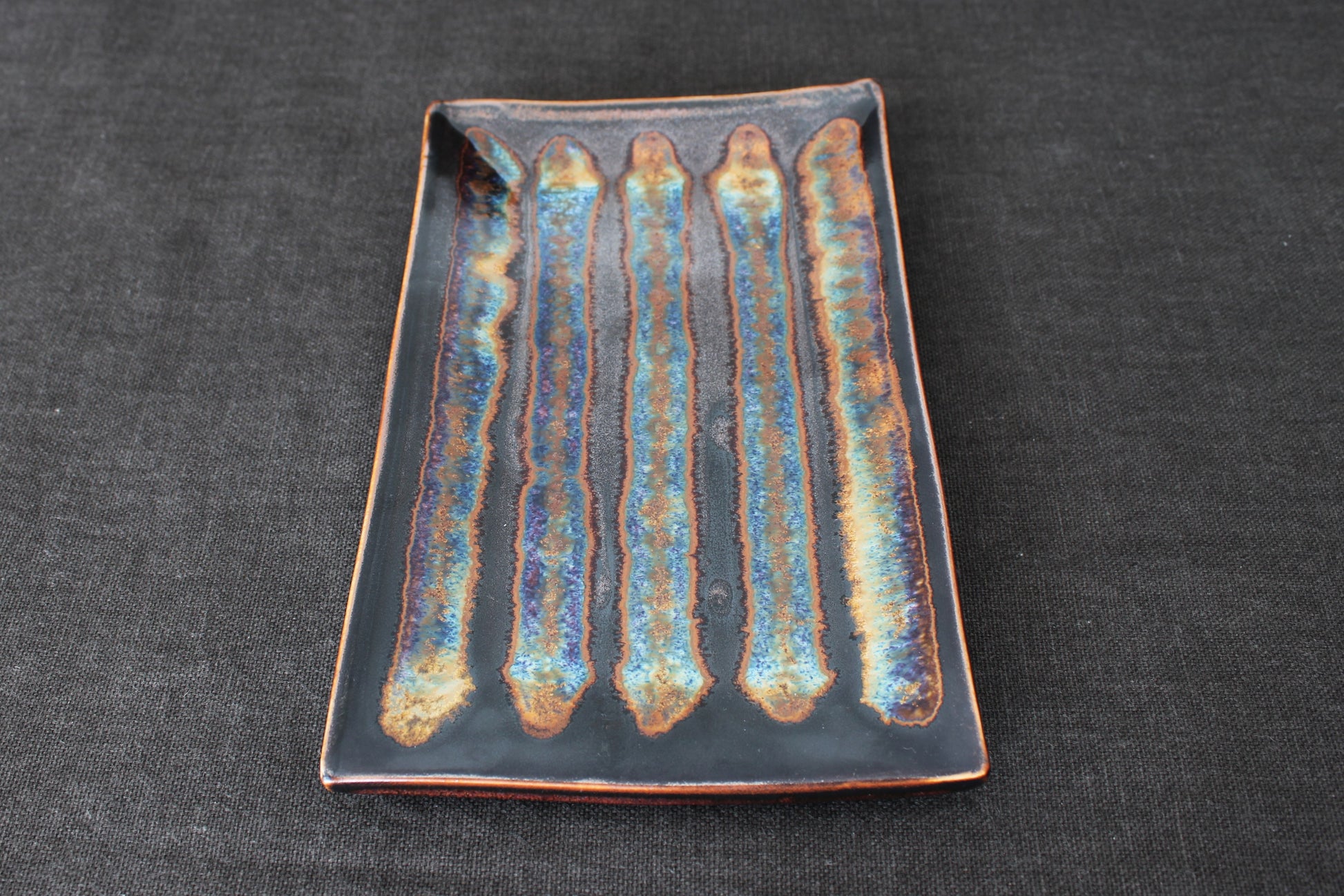 sushi plate with tenmoku glaze top view