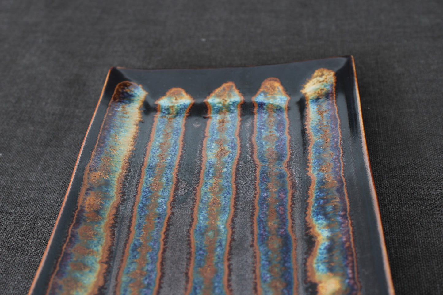 sushi plate with tenmoku glaze top view