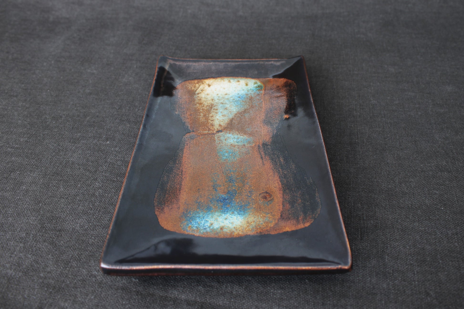 sushi plate with tenmoku glaze top view